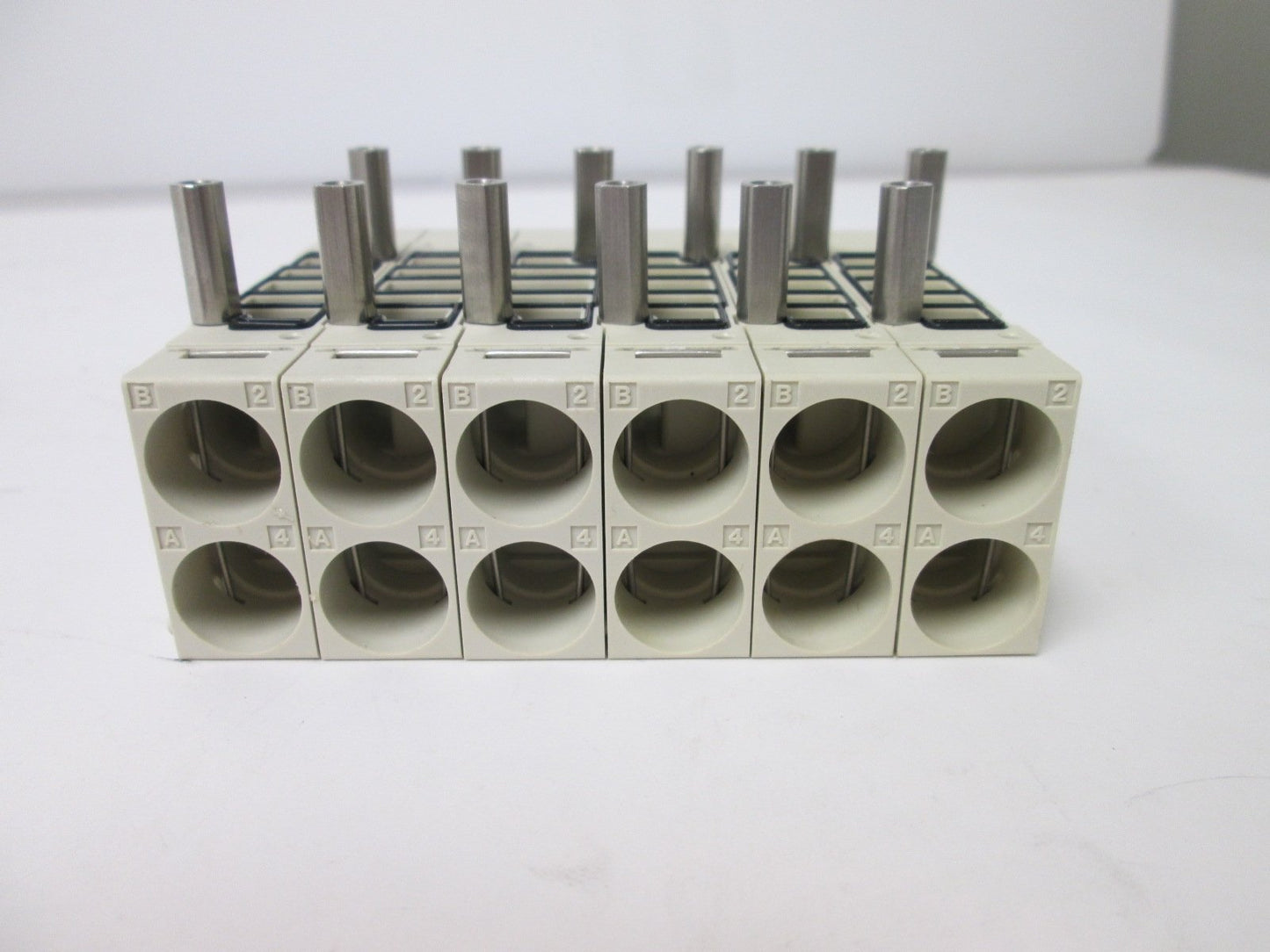 Used Bank of 6 SMC SV2000-50-1A-N7 Manifold Blocks, Voltage Rating: 12/24VDC