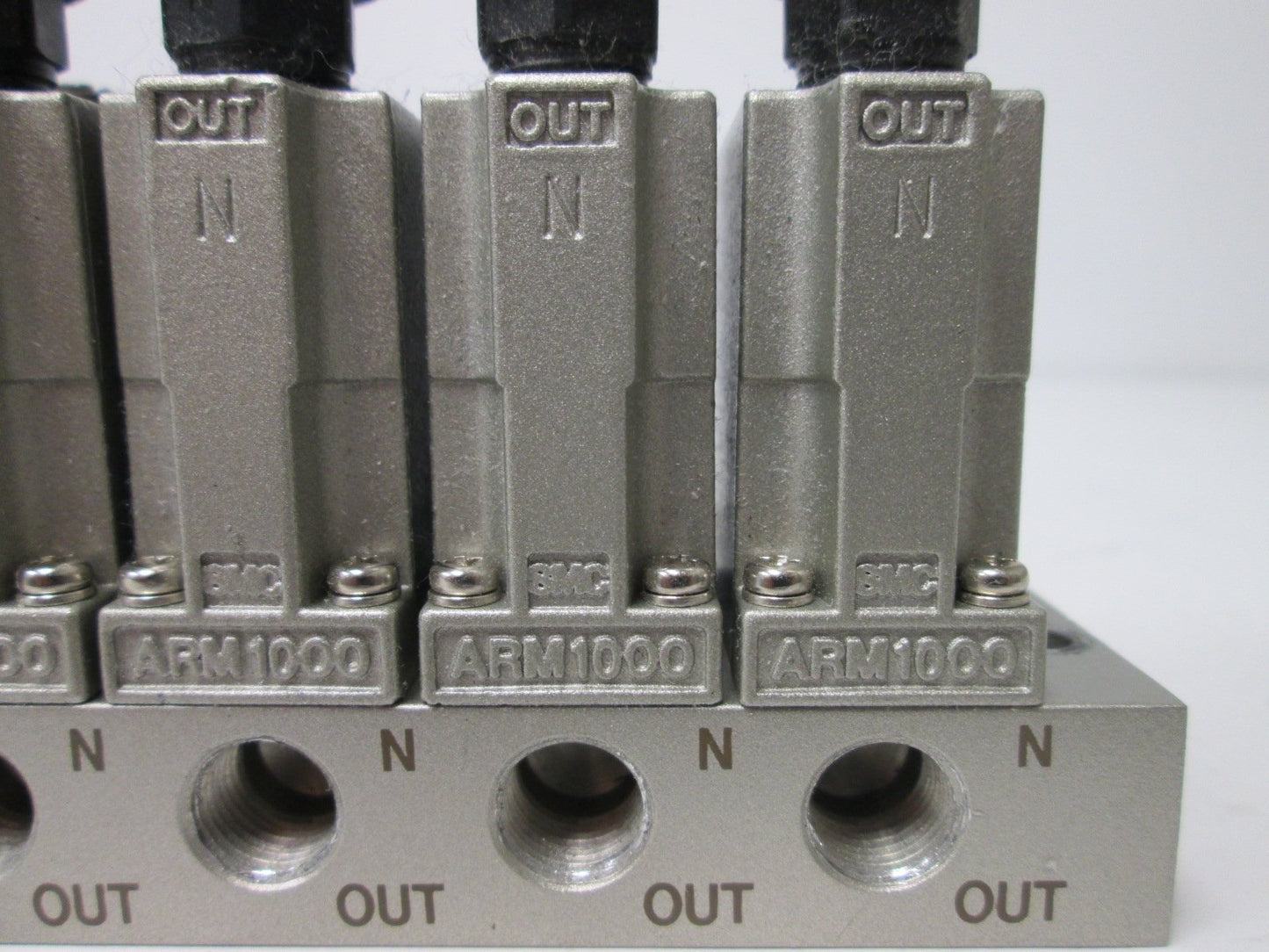 Used Bank of 6 SMC ARM1000 Manifold Regulators, With 0-150psi Gauge, 1/8" Ports
