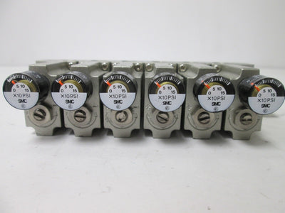Used Bank of 6 SMC ARM1000 Manifold Regulators, With 0-150psi Gauge, 1/8" Ports
