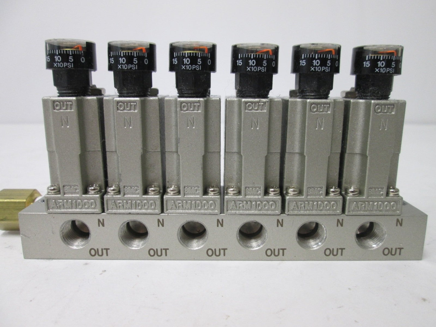 Used Bank of 6 SMC ARM1000 Manifold Regulators, With 0-150psi Gauge, 1/8" Ports